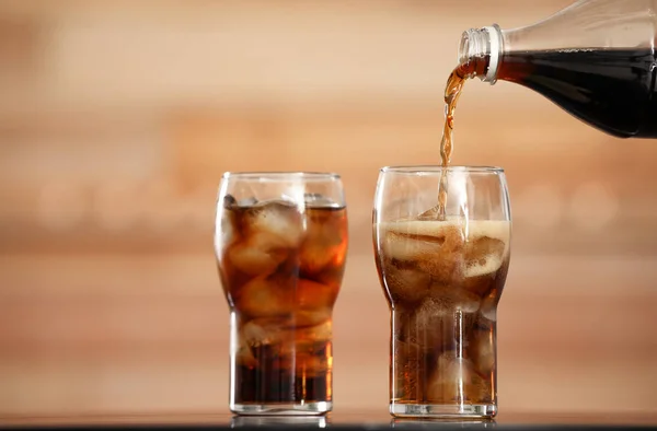 Pouring Cola Bottle Glass Ice Cubes Table Blurred Background — 스톡 사진