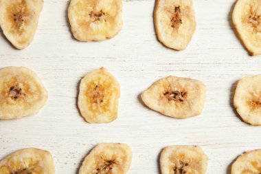 Ahşap masa muz dilimleri ile düz yatıyordu kompozisyon. Kurutulmuş meyve sağlıklı çerez olarak