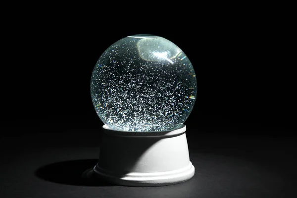 Magical empty snow globe on dark background