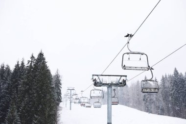 Ski lift at snowy mountain resort. Winter vacation