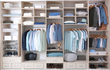Stylish clothes, shoes and home stuff in large wardrobe closet clipart