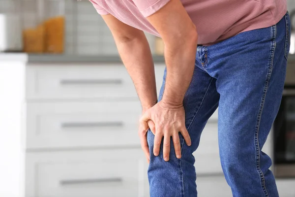 Senior Man Suffering Knee Pain Kitchen Closeup Space Text — Stock Photo, Image
