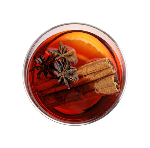 Glass of mulled wine with spices isolated on white, top view