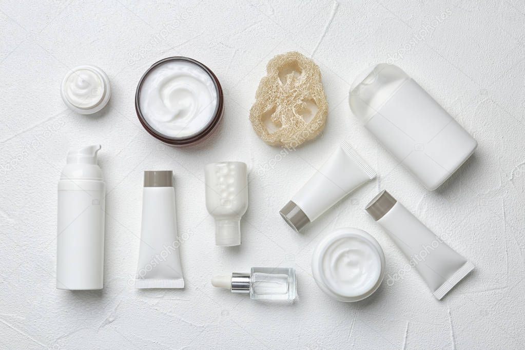 Flat lay composition with body care products on white background