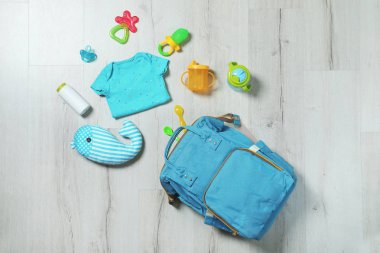 Flat lay composition with baby accessories on wooden background clipart