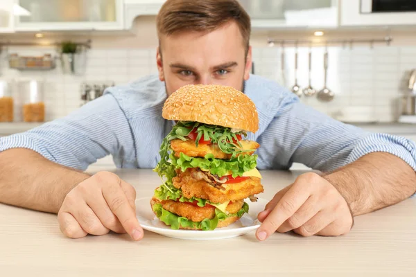 Young Dreamy Man Holding Plate Huge Burger Table — Stock Photo, Image