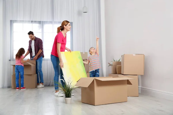 Happy Family Unpacking Belongings Pile Moving Boxes Indoors — Stock Photo, Image