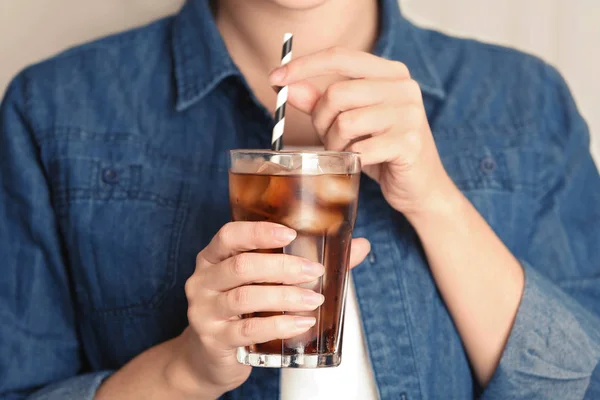 Woman with glass of tasty refreshing cola, closeup view