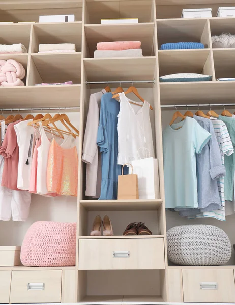 Stylish clothes, shoes and home stuff in large wardrobe closet