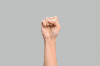 Woman showing S letter on grey background, closeup. Sign language clipart