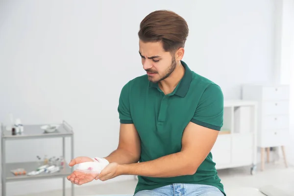 Young Man Applying Bandage Injured Arm Home First Aid — Stock Photo, Image