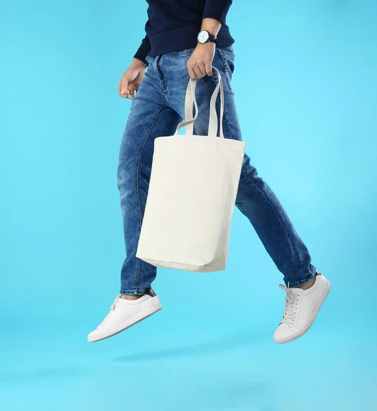 Young Man Holding Textile Bag Color Background Closeup Mockup Design — Stock Photo, Image