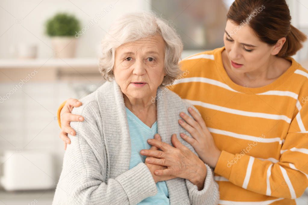 Elderly couple with female caregiver at home