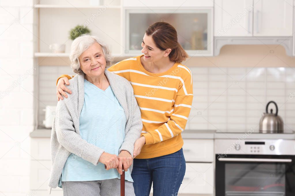 Elderly couple with female caregiver at home