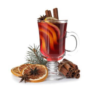 Composition with glass cup of mulled wine, cinnamon, orange and fir branch on white background clipart