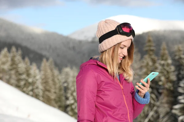 Νεαρή Γυναίκα Γυαλιά Σκι Χρησιμοποιώντας Smartphone Στα Βουνά Κατά Διάρκεια — Φωτογραφία Αρχείου