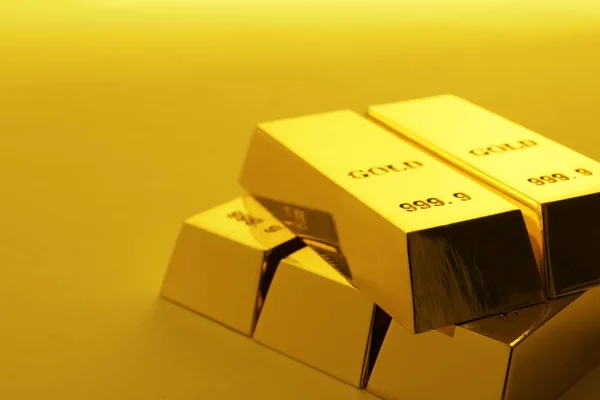 Precious shiny gold bars on color background