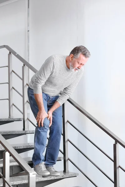 Senior Man Suffering Knee Pain Indoors — Stock Photo, Image