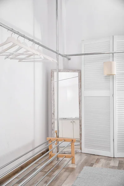 Empty modern dressing room with racks and hangers