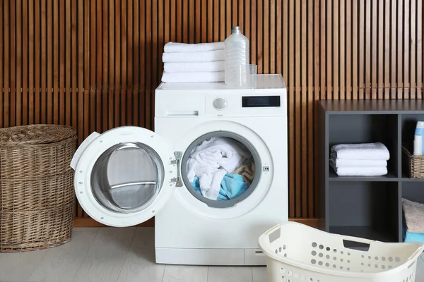 Crumpled towels in washing machine at home. Laundry room interior