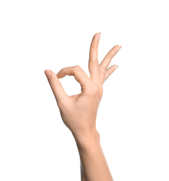 Woman showing sign okay on white background, closeup. Body language