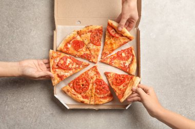 Karton kutu tablo, en iyi görünüm vasıl dilim sıcak peynir pizza alarak gençler. Gıda dağıtım hizmeti