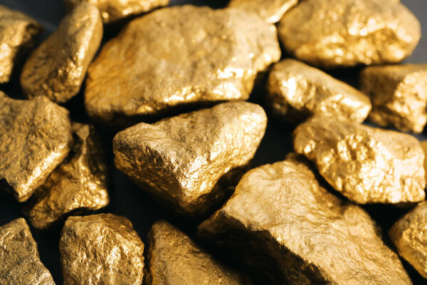 Pile of gold nuggets as background, closeup