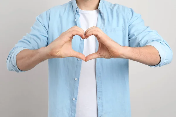 Man Making Heart His Hands Light Background Closeup — Stock Photo, Image