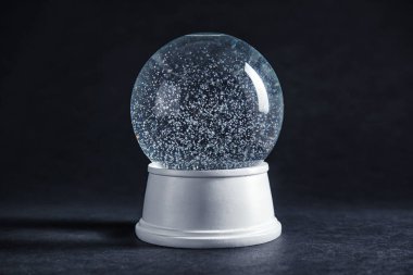 Magical empty snow globe on dark background clipart
