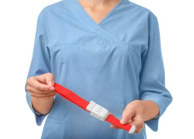 Female doctor holding tourniquet on white background, closeup. Medical object clipart