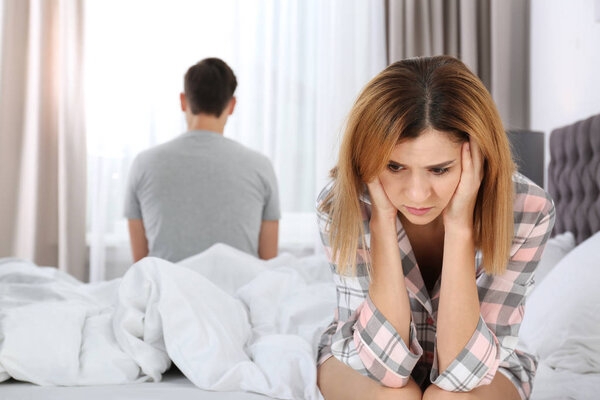 Couple with relationship problems in bed at home
