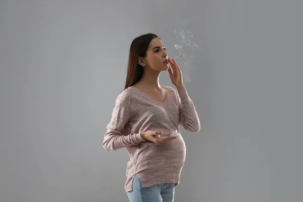 Young Pregnant Woman Smoking Cigarette Grey Background — Stock Photo, Image