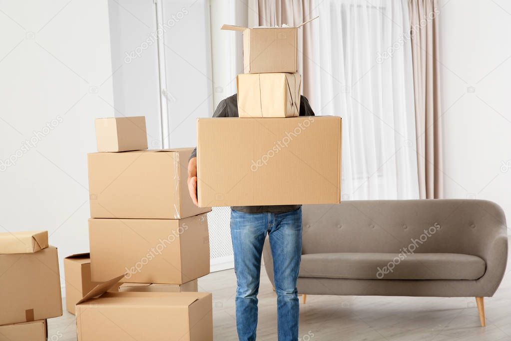 Man with moving boxes in his new house