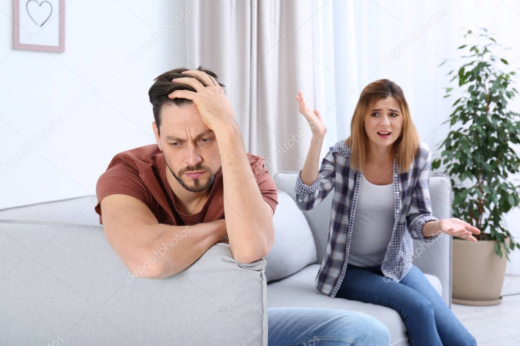Couple arguing in living room. Relationship problems