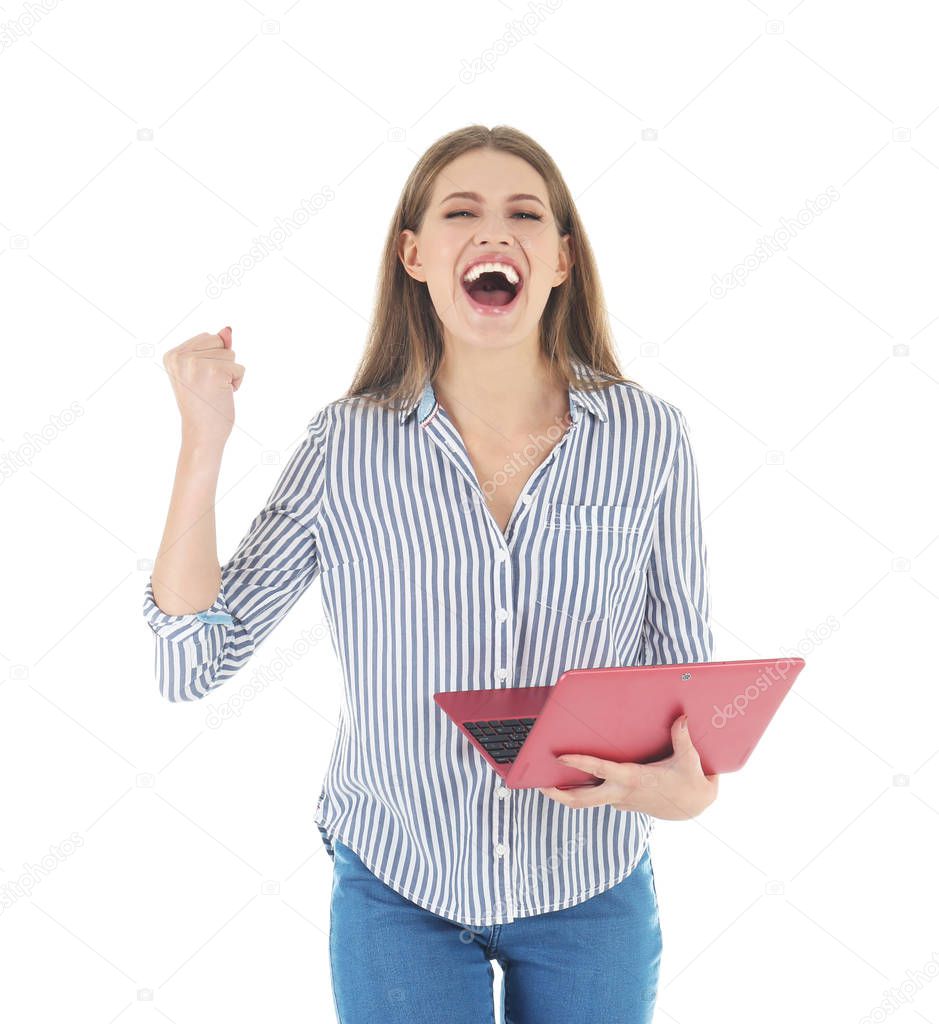 Emotional young woman with laptop celebrating victory on white background