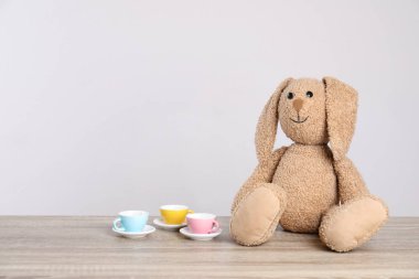 Sevimli Peluş bunny ve oyuncak sofra ışık arka plan, metin için yer karşı masada. Çocuk odası elemanları
