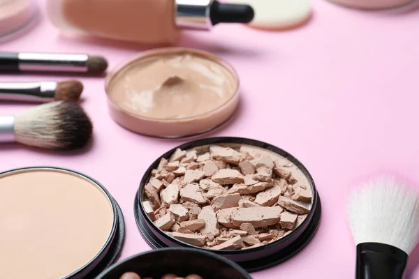 Composition with powder, skin foundation and beauty accessories on color background