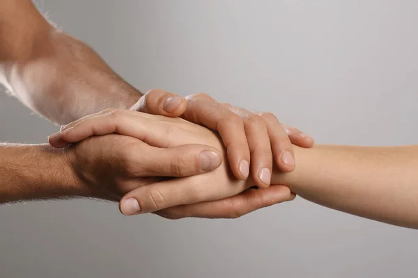 Man Comforting Woman Grey Background Closeup Hands Help Support Concept — Stock Photo, Image