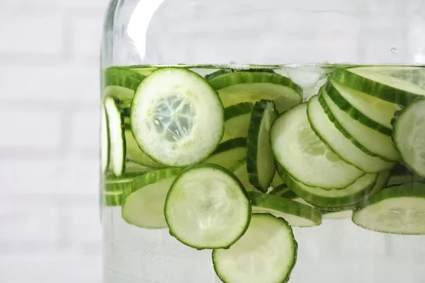 Large jar of fresh cucumber water, closeup