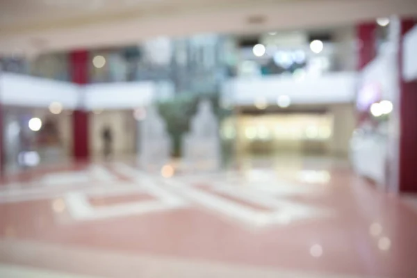 Blurred view of shopping mall entrance hall interior