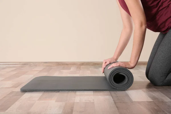 Woman Rolling Yoga Mat Floor Indoors Closeup Space Text — Stock Photo, Image