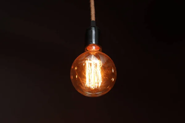 Glowing lamp bulb in darkness. Interior element