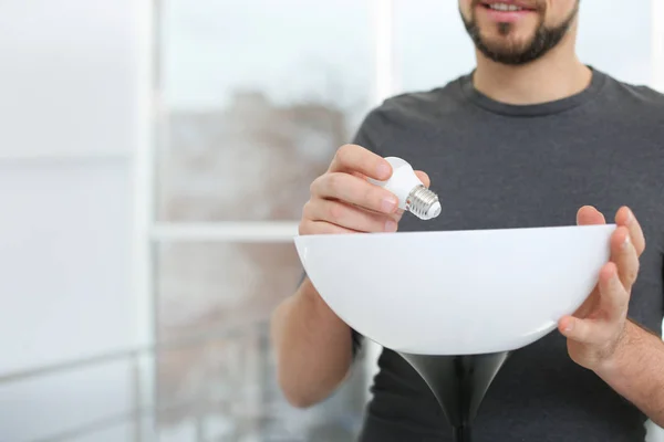 Man Changing Light Bulb Lamp Indoors Closeup Space Text — Stock Photo, Image