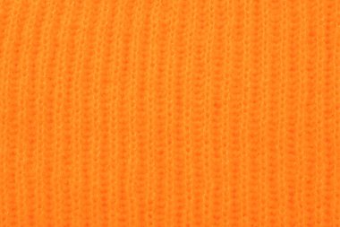 Arka plan, closeup olarak turuncu örme kumaş dokusuna