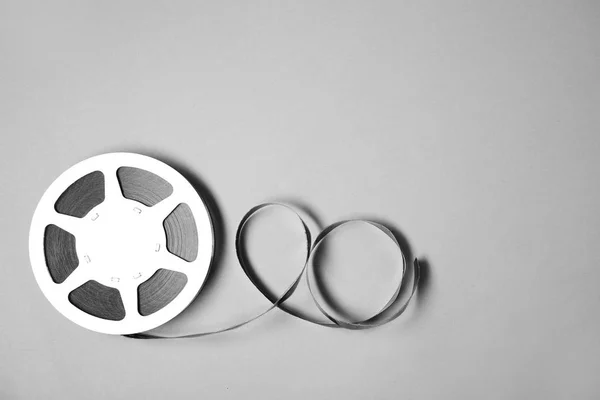 Movie reel on grey background, top view with space for text. Cinema production