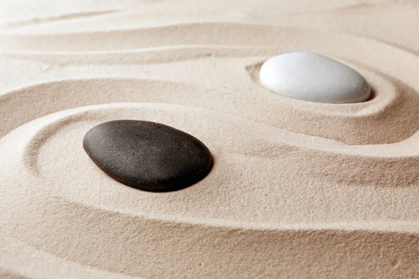 Zen garden stones on sand with pattern. Meditation and harmony