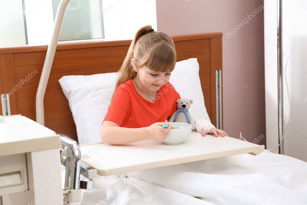 Little child with intravenous drip sleeping in hospital bed