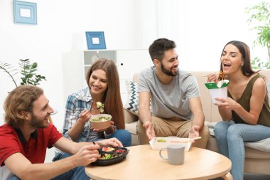 Oturma odasında birlikte yemeğe gençler. Food teslim