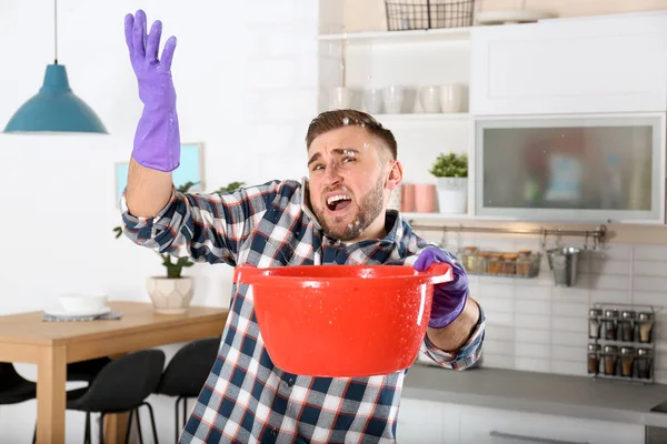 Emotional Young Man Calling Plumber While Collecting Water Leakage Ceiling — Stock Photo, Image