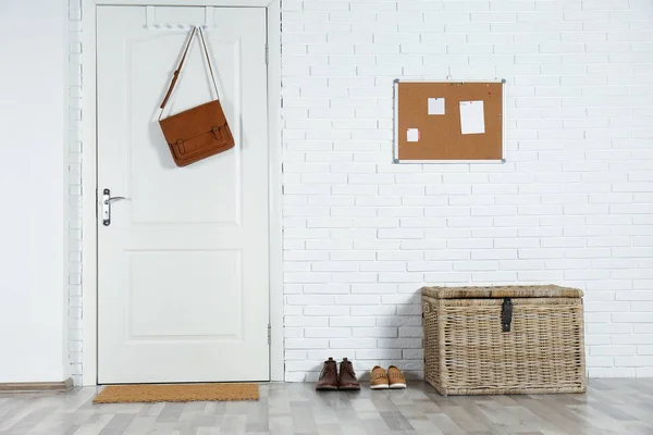 Hallway interior with white door and mat